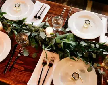 white ceramic dinner plate set on brown wooden table
