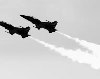 a couple of jets flying through a cloudy sky